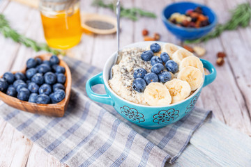 oatmeal with banana and blueberries in a blue bowl