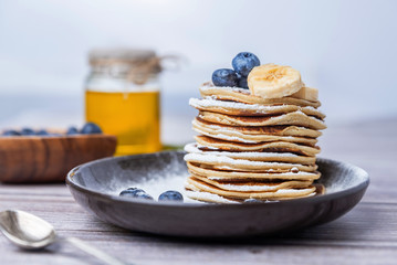 .American pancakes with blueberries and honey