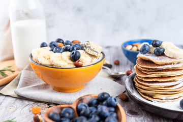 rustic Breakfast pancakes on a plate with blueberries and oatmeal