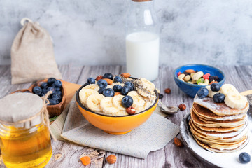 rustic Breakfast pancakes on a plate with blueberries and oatmeal - 308900261