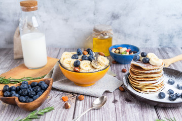 rustic Breakfast pancakes on a plate with blueberries and oatmeal