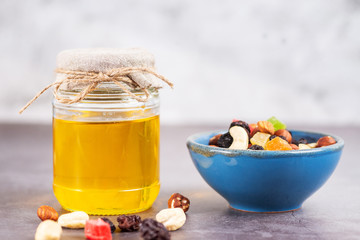 vegetarian snack healthy food nuts and dried fruit with a jar of honey