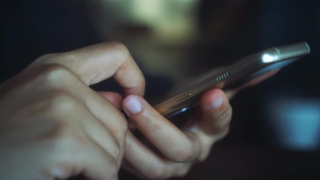 4k video People hand using smartphone with blur cafe shop background. Business, financial, trade stock maket and social network concept.