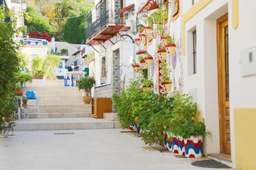 Beautiful typical alley of Barrio Santa Cruz in Alicante, Costa Blanca, Spain - obrazy, fototapety, plakaty