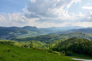 View of the mountain road, blue sky, mountains on the horizon.