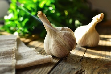 Garlic on a wooden background. The beneficial properties of garlic.