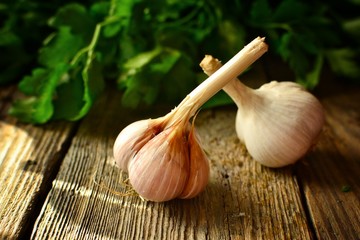 Garlic on a wooden background. The beneficial properties of garlic.