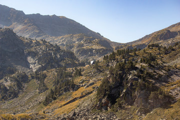 Fototapeta premium In the distance, Refuge of Campana de Cloutou in the Pyrenees mountains