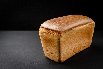 Rye bread on black background.
