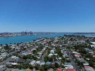 Devonport, Auckland / New Zealand - December 11, 2019: The Victorian Style Seaside Village of Devonport, with the skyline of Auckland’s landmarks and CBD in the background