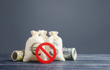 Money bags and red prohibition symbol no. Capital export outflow restrictions. Sanctions....