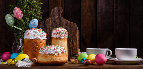 Easter cake and colorful eggs on a dark background