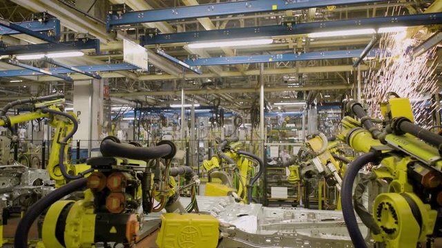Automated robots at work inside an automobile manufacturing plant