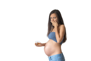Pregnant woman with glass of whiskey indoors. No alcohol during pregnancy. Pregnant woman rejecting...