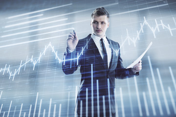 Businessman and forex graph hologram. Double exposure. Concept of financial education and analysis