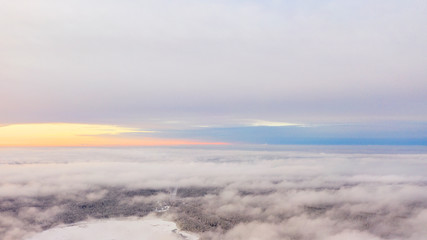 Obraz premium Aerial view White clouds in blue sky. Top view. View from drone. Aerial bird's eye view. Aerial top view cloudscape. Texture of clouds. View from above. Sunrise or sunset over clouds