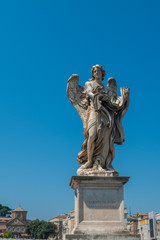 Fototapeta na wymiar On the bridge of Sant Angelo the Angel with the Garment and Dice in Rome, Italy