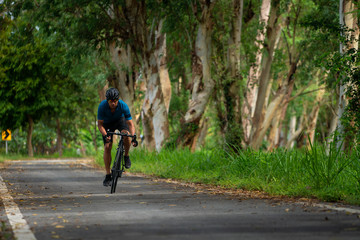 man cycling bicycle for exercise on the road in morning