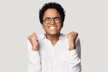 Excited euphoric young african american lucky woman celebrating success.