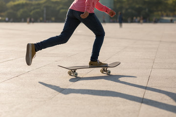 Skateboarder skateboarding at sunset city
