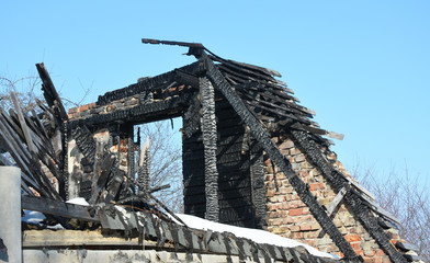 Fototapeta na wymiar House Rooftop Fire Damage. House Roof Burns Down.