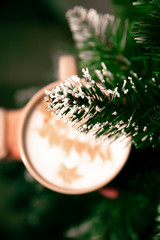 Cup with coffee on christmas tree background