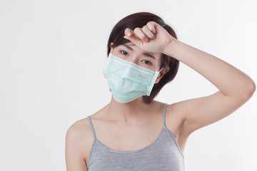 Young beautiful Asian female model with short hair in sick action on the white background