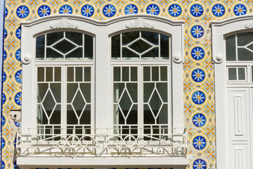 facade covered with azulejos on an old house in Olhao, Algarve, Portugal