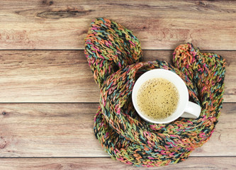 Obraz na płótnie Canvas cup of latte coffee wrap in colorful scarf.