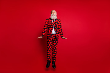 Full length photo of cool aged attractive guy man amour role play jumping high up rejoicing wear...