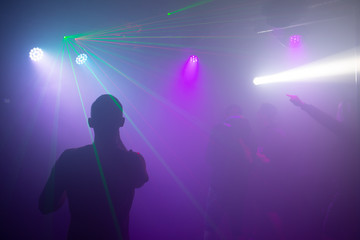 Fototapeta na wymiar Dancing silhouette lights and Laser dico nightclub