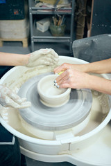 Women making ceramic pottery, concept for workshop and master class, four hands close-up, focus on potters, palms with pottery. Creative hobby concept. Earn extra money, side hustle