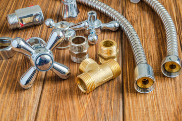 Spare parts and accessories for plumbing repair on vintage wooden boards