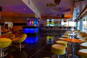 lounge bar of modern European resort hotel, interior with terrace, tables, lighting. Rhodes, Greece