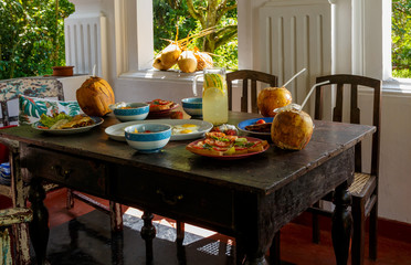Colorful table and furniture in Sri Lanka Villa, covered with variety of natural healthy food with fruit on the terrace.
