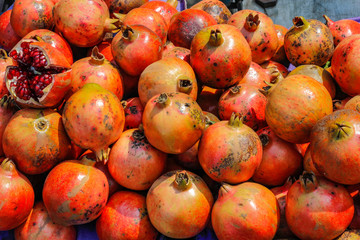 A bunch of whole ripe pomegranates.