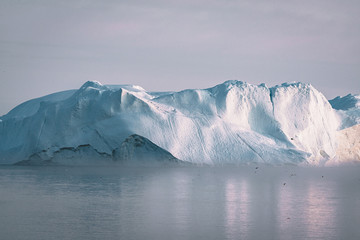 Iceberg at sunset. Nature and landscapes of Greenland. Disko bay. West Greenland. Summer Midnight...