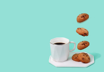 Cup of coffe with flying biscuits.