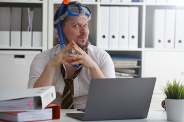 Man wearing suit and tie in goggles with snorkel