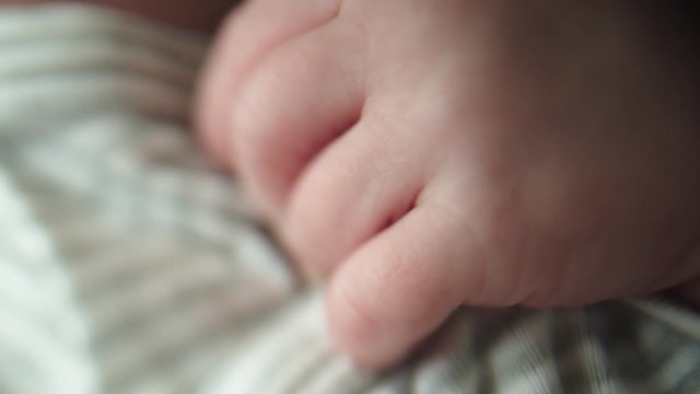 Close up of newborn baby arms and little tiny fingers