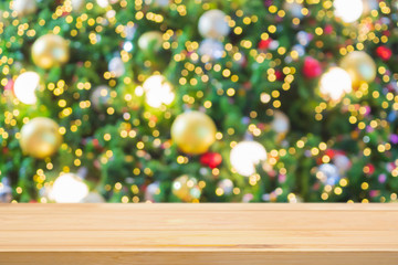 Empty wood table top with Abstract blur Christmas tree with decoration bokeh light background for product display