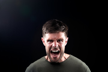 Fototapeta premium Head And Shoulders Studio Shot Of Angry Man Shouting At Camera