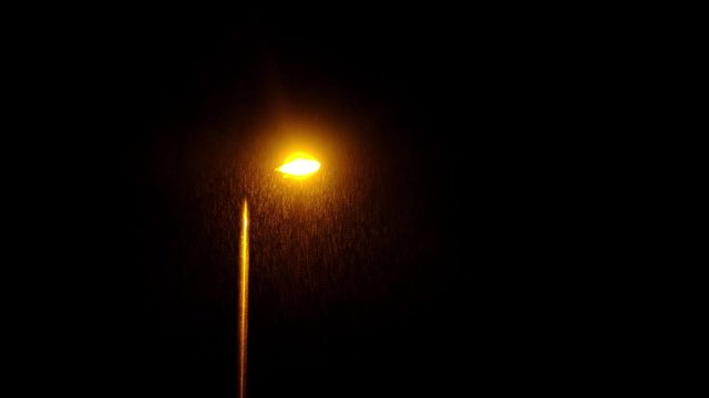 Wind and heavy rain over lamp post at night. Night scene footage.