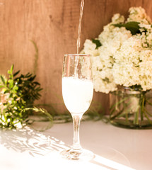 Rose blush wine in glasses. Bottle of rose wine with flowers on background. Prosecco.