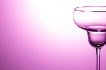 Empty wine glass on purple background. Back space.