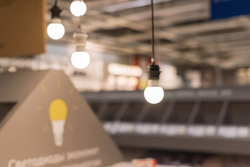 Blurred background of electrical good department in hardware store with lighting fixtures in a shopping center
