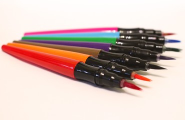 color pencils, paints on a white background, isolated, selective focus