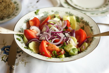 Vegetable salad. Georgian salad of cucumbers, tomatoes, onions and herbs