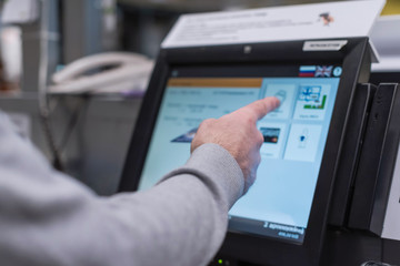 Man paying at the self-service counter using the touchscreen display and credit card. Isometric...