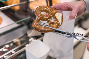 Man buying pretzels in a pastry shop for Christmas